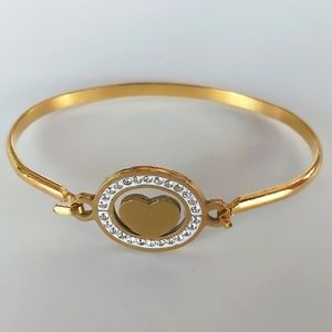 CUFF BRACELET STAINLESS STEEL GOLD COLOR, middle piece gold heart and crystals.